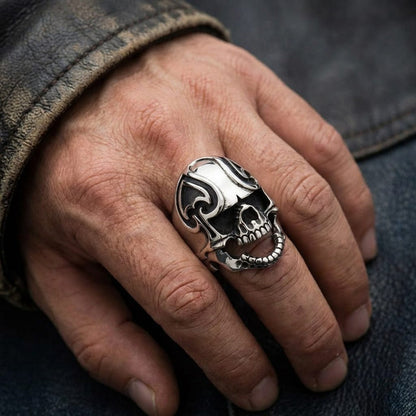Lifestyle shot showing the heavy 30-gram silver skull ring worn on a hand, highlighting the prominent spade carving on the forehead.
