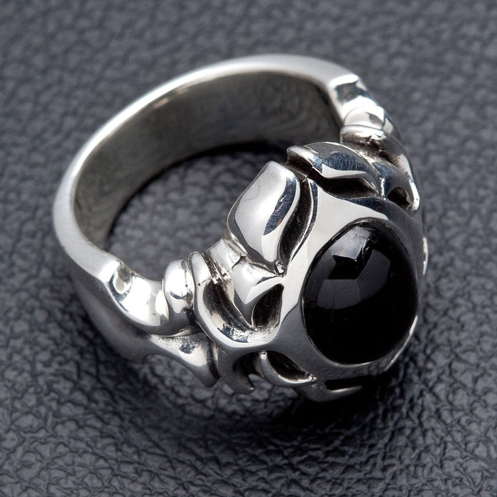 Low angle through the band showing the solid sterling silver shank and the smooth black onyx cabochon set into the face
