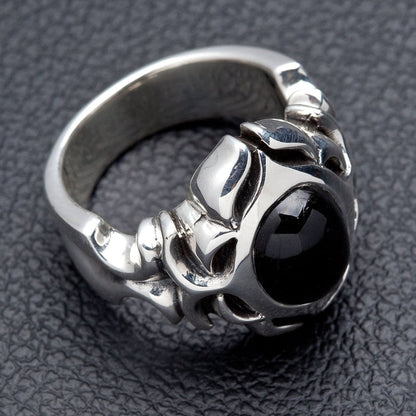 Low angle through the band showing the solid sterling silver shank and the smooth black onyx cabochon set into the face