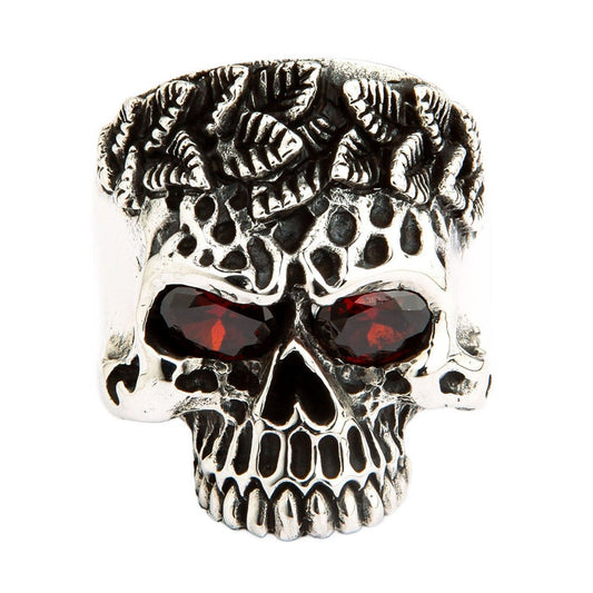 A heavy and solid sterling silver tribal skull ring, featuring intricate carvings and two fiery, brilliant red CZ eyes.