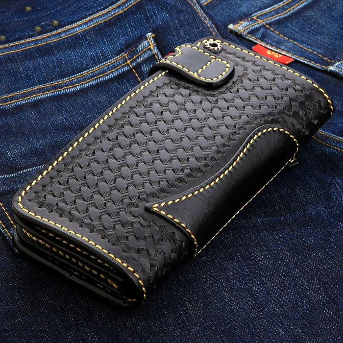 Basketweave panel framed by smooth black leather, thick yellow stitching and a metal snap on the strap.