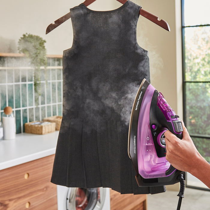 lady using morphy richards iron