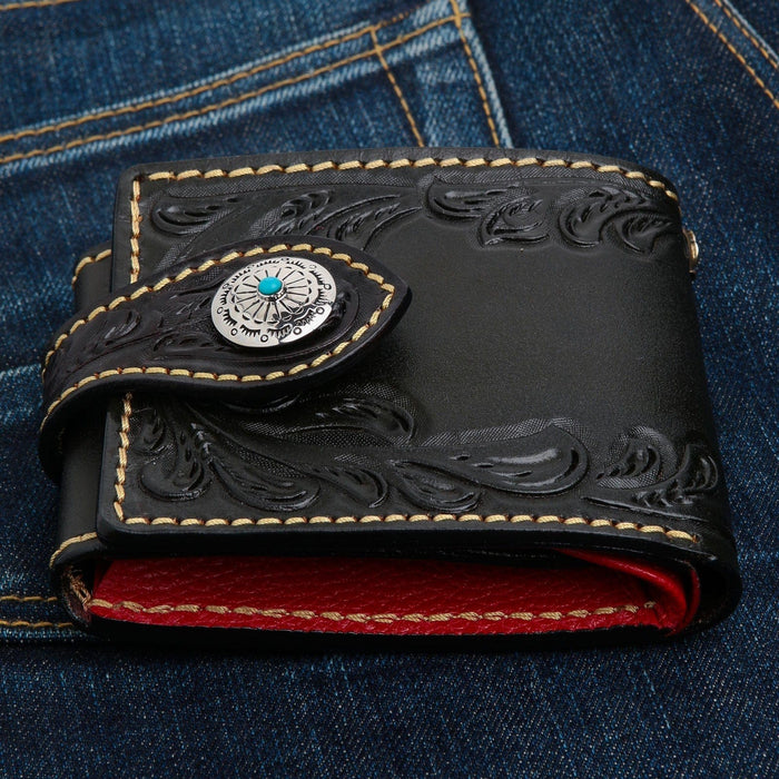 A premium, hand-tooled leather Turquoise Indian biker wallet with a bold red interior and a silver concho.