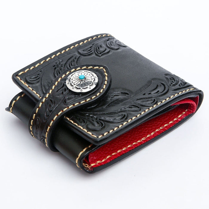 A bifold biker wallet showing its silver grommet for a wallet chain and its beautiful, deep hand-tooled details.