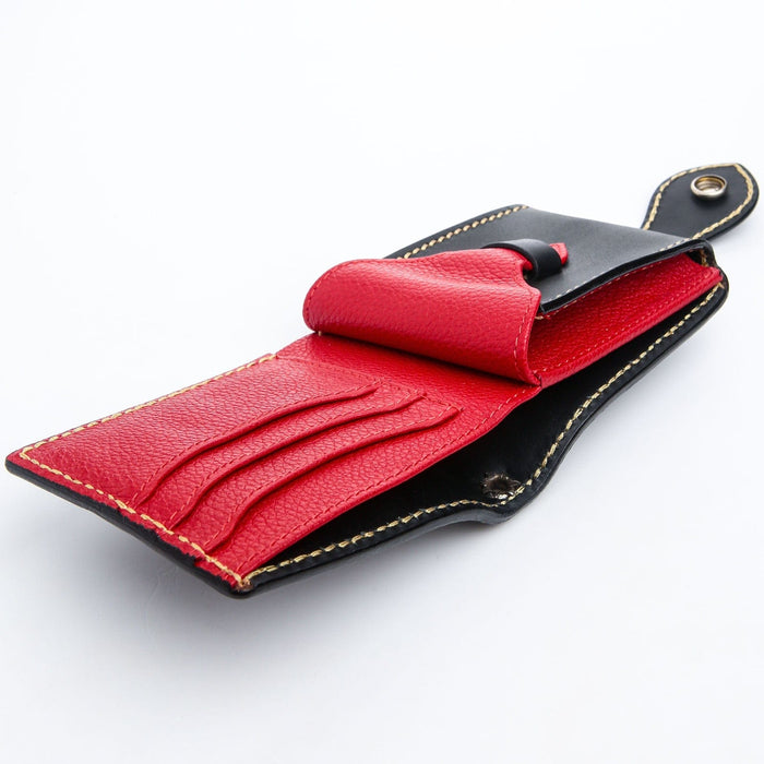 The fully open interior of the tooled leather wallet, showing its vibrant red leather lining, card slots, and coin pocket.
