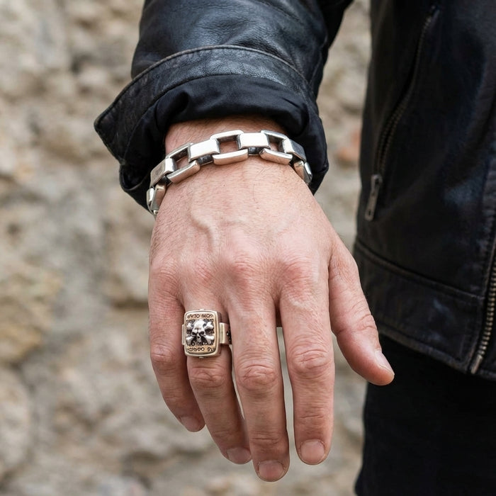 Men's silver skull ring styled with leather jacket and bracelet