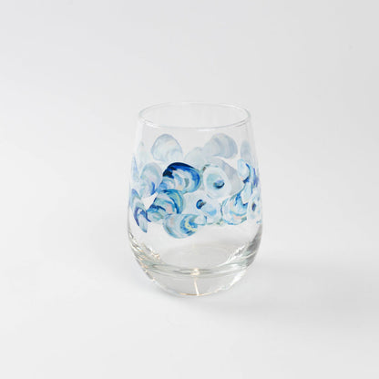 Wine glass with blue oyster pattern against white background