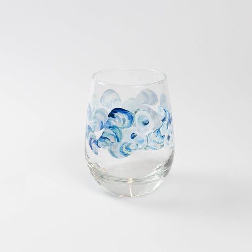 Wine glass with blue oyster pattern against white background