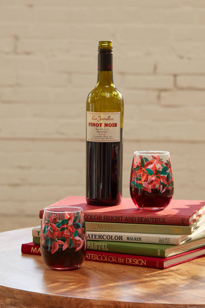 Poinsettia wine glasses against beige background
