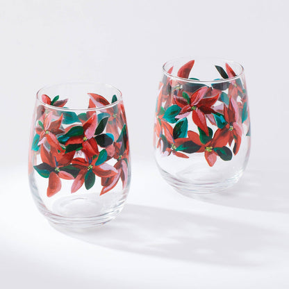 Set of two wine glasses with poinsettia pattern against white background
