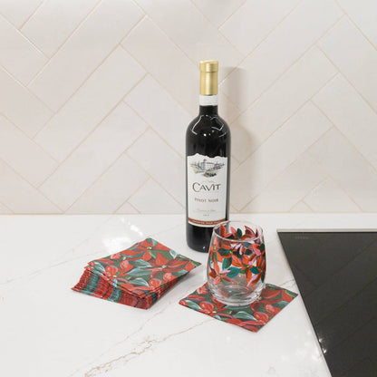 Wine glass with poinsettia pattern against white background