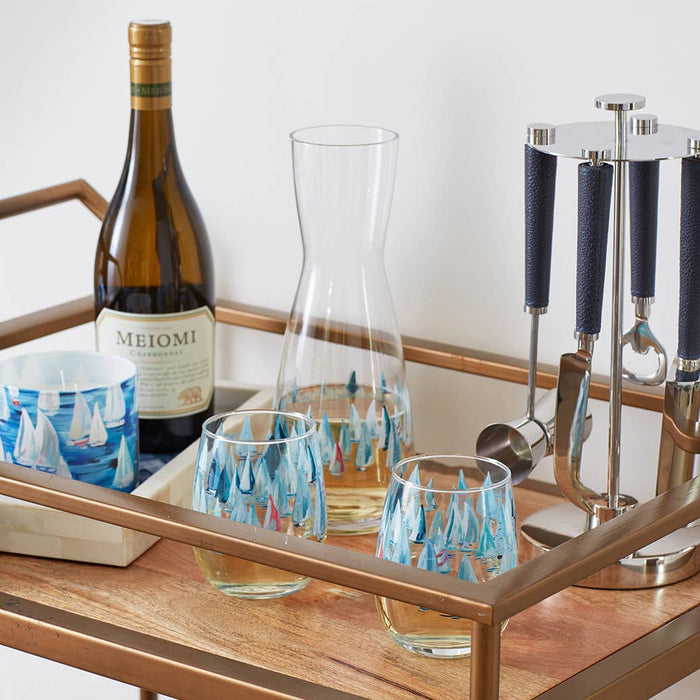 Stemless wine glasses with sailboat pattern on a bar cart