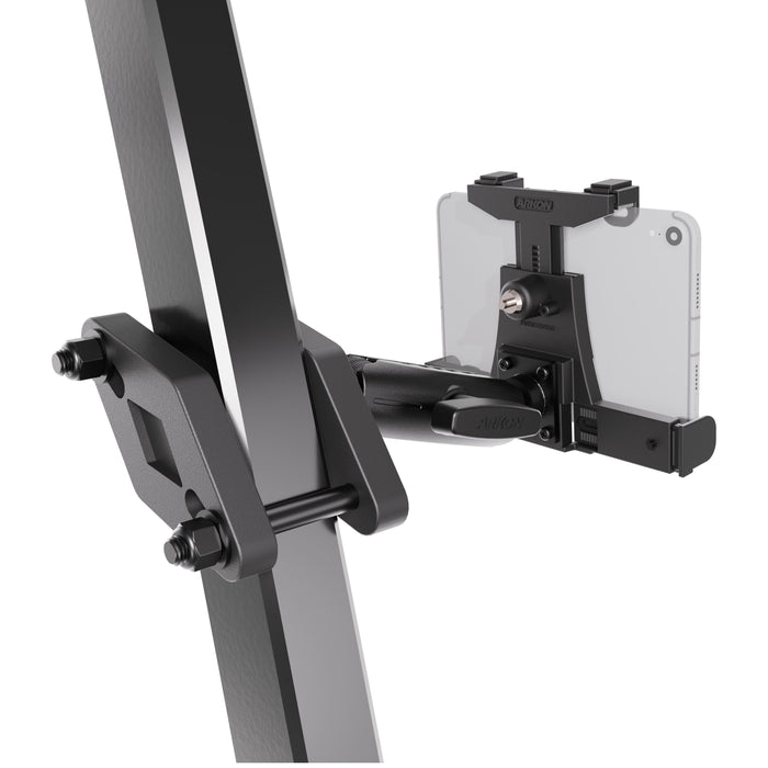 A black metal clamp attached to a vertical beam holds the XMS™ Heavy Duty Forklift Mount with LockVise™ Locking Tablet Holder, featuring an adjustable arm that securely grips a smartphone in landscape orientation—mirroring the robust and secure design commonly found in warehouse tablet mounting systems.