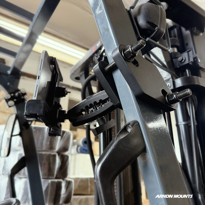 A close-up of a metal forklift frame with the XMS™ Heavy Duty Forklift Mount and LockVise™ Locking Tablet Holder securely attached, featuring the Arkon Mounts logo in the bottom right corner. This robust warehouse tablet mounting system provides secure and convenient access to your devices while on the move.