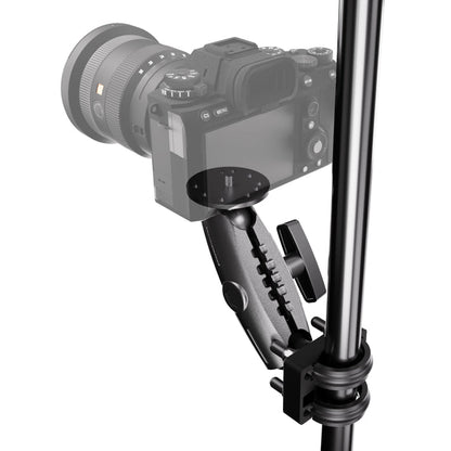 A camera is mounted to a vertical metal pole using the XMS™ U-Bolt Mount with Camera Pedestal, which features an adjustable clamp arm, a round mounting plate, and tightening knobs.